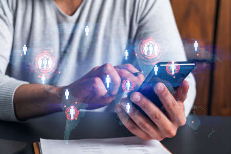 Man using phone. Hands typing smartphone. Double exposure with world map planet earth hologram....