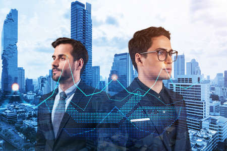Two entrepreneurs in suits pondering about new venture capital and hi-tech start up and try to forecast risks and estimate prospective earning growth. Hologram chart on Bangkok background.の写真素材