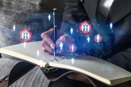 Planet earth map hologram and a woman taking notes. International network concept. Multiexposure.