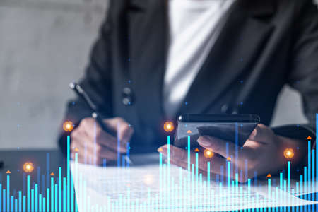 Financial chart hologram and a woman signing contract use phone. Double exposure. Analysis concept.