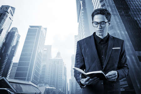Young handsome businessman in suit and glasses thinking how to tackle the problem, new career...