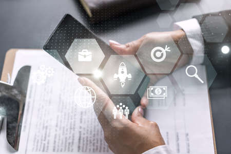 Businesswoman using smart phone in office. Research and development icon map hologram. Strategy...