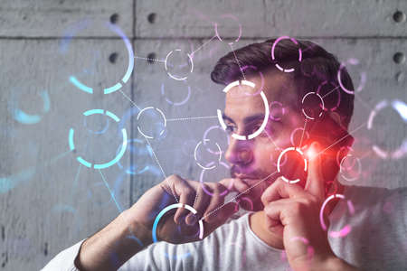 A man in casual wears, speaks phone. Double exposure. Abstract technology drawings hologram.