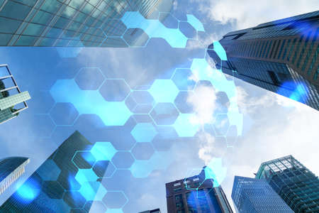 Abstract technology icons hologram on low, wide angle view of glass and steel contemporary...