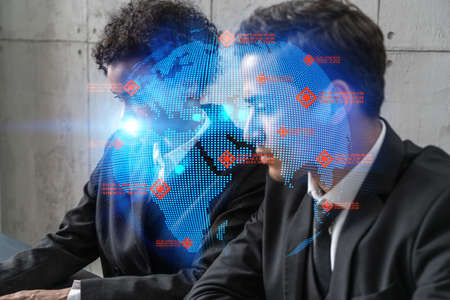 Two good looking businesspeople working on international project. Multiexposure. World map Hologram.