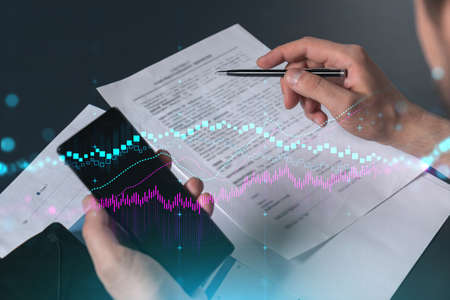 Multi exposure of man signing contract with phone and forex chart hologram. Concept of financial...
