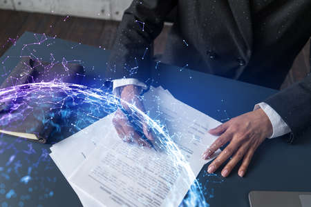 Woman signs contract with abstract network hologram. Double exposure.の写真素材