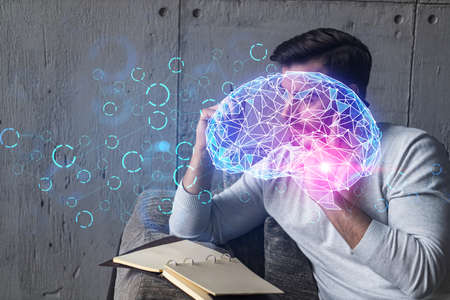 Handsome man talking phone and making notes at office workplace. Multiexposure. Brain hologram as a concept of artificial intelligence.の写真素材