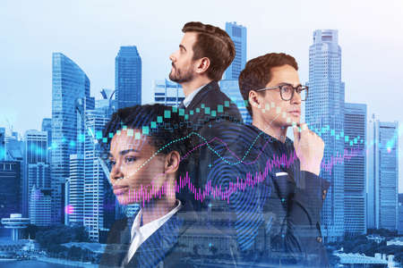 Group of business colleagues working on new venture capital and hi-tech start up and try to forecast risks and estimate prospective earning growth. Hologram chart on Singapore background.の写真素材