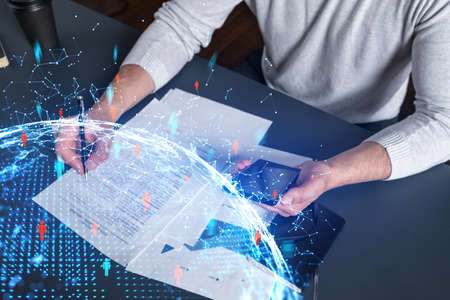 Double exposure of man signing contract with phone and social network icon hologram. Concept of...