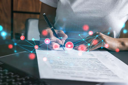 Woman signs contract with abstract network hologram. Double exposure.の写真素材