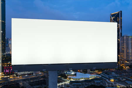 Blank white road billboard with KL cityscape background at night time. Street advertising poster,...