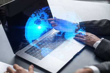 Man and woman working together on international business project. Blue infographic hologram of...