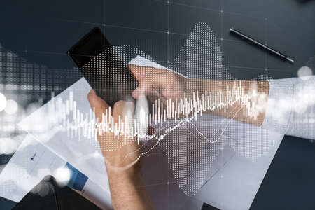 Man using phone. Hands typing smartphone. Double exposure with forex graph hologram. Close up....