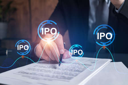 Businessman in suit signs paper. Double exposure with IPO icon hologram. Man signing contract...