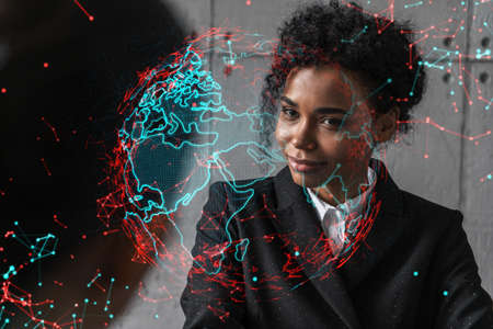 Two businesswomen work together in modern office on new project. Double exposure. Concept of success. Planet earth world map.の写真素材