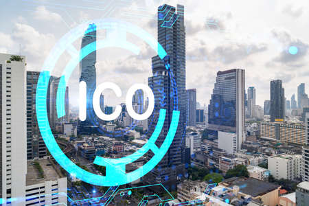ICO icon hologram over panorama city view of Bangkok, the hub of blockchain projects in Asia. The...