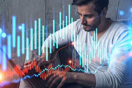 A serious caucasian analyst in casual wears, using laptop to proceed the forecast of stock market...