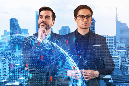 Two handsome young SMM specialists thinking about development of social media marketing strategy to...