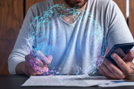 Double exposure of man signing contract with phone and world map network hologram. Concept of...