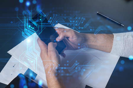Man using phone. Hands typing smartphone. Double exposure with technology hologram. Close up....