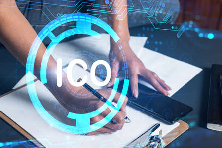 Businesswoman taking notes using smart-phone. ICO drawing hologram double exposure. Blockchain...