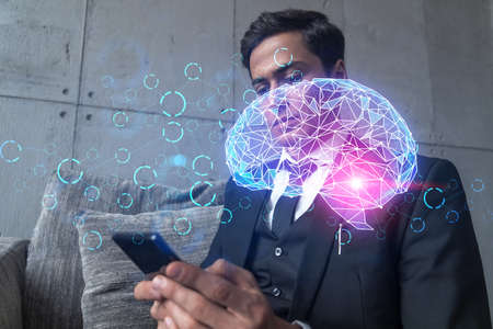 Businessman in office working with Smartphone, Brain hologram to optimize the process, typing phone. Double exposure.の写真素材