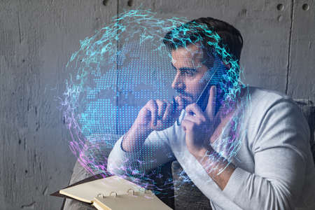 Handsome businessman in casual wears, speaking phone, taking notes at office try to solve global...