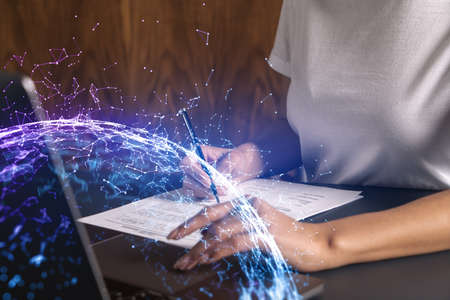 Businesswoman typing on laptop in office. Abstract technology hologram. Double exposure.