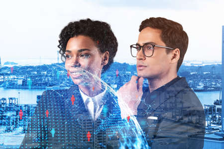 Businessman and businesswoman as a SMM specialists thinking about development of social media marketing strategy to achieve business goals. Hologram icons over Singapore background.の写真素材