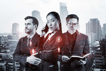 Group of SMM specialists working on social media marketing strategy to achieve business goals. Hologram icons over Bangkok background.の写真素材