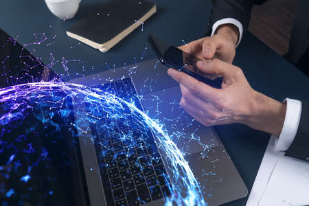 Double exposure of man texting on phone on high tech project. Technology hologram. Concept of...