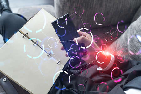 Double exposure of man texting on phone on high tech project. Technology hologram. Concept of...
