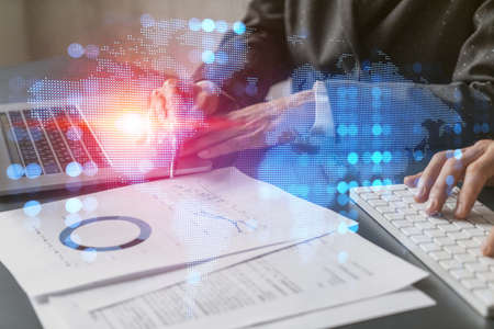 Double exposure of people working together background and world map hologram. Inernational business.