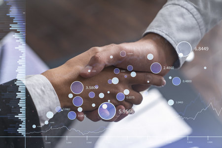 A handshake as a symbol of successful transaction on brokerage services at international investment bank. Capital market, stock trading. Financial hologram chart. Women in business.の写真素材