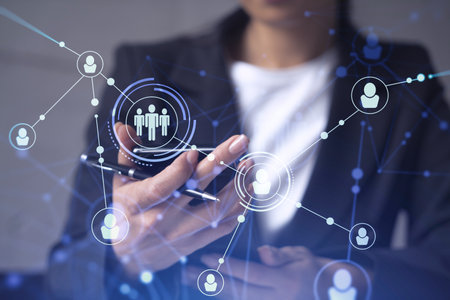 HR woman specialist in formal wear browsing social networks in the Internet in smart phone to find the best candidates to hire international team. Concept of success. Media hologram icons.の写真素材