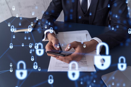 A businessman in formal wear reading the contract to prevent probability of risks in cyber security and checking details in the phone. Padlock Hologram icons over the working desk.の写真素材