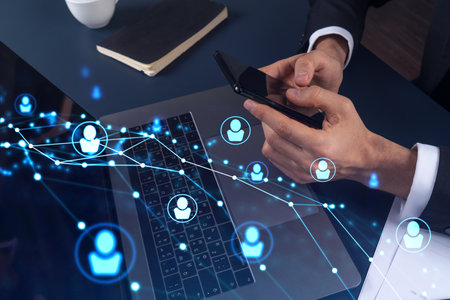 Hands of hr specialist browsing social networks in the Internet in smart phone to find the best...