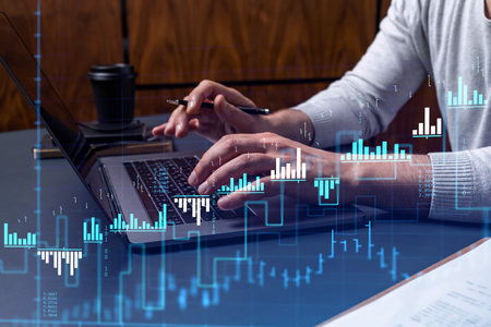 Hands typing the keyboard to research stock market to proceed right investment solutions. Internet...