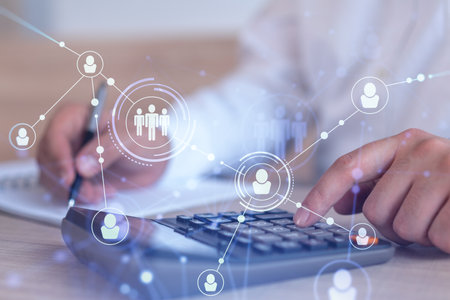 HR specialist researching and analyzing the data of salary on employment market to forecast ongoing expenses of the company using calculator. Hiring new talented officers. Social media hologram iconsの写真素材