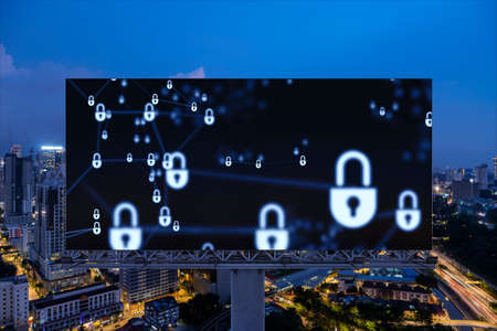 Padlock icon hologram on road billboard over panorama city view of Kuala Lumpur at night to protect...