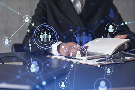 Woman HR specialist is taking notes concerning new candidates to create international network in...