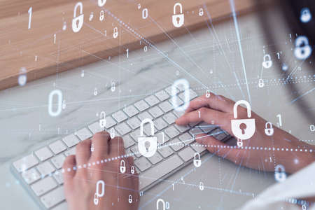 A woman programmer is typing a code on computer to protect a cyber security from hacker attacks and...
