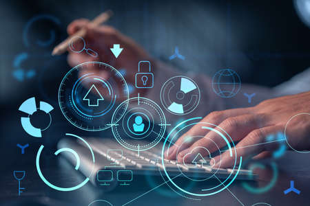 Hands typing the keyboard to create innovative software to change the world and provide a completely new service. Close up shot. Hologram tech graphs. Concept of Dev team. Formal wear.の写真素材