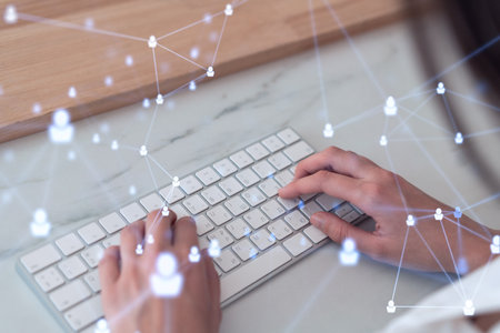 HR woman specialist is typing the keyboard in the internet to find the best candidates to create international network in recruitment process. Formal wear. Social media hologram icons.の写真素材