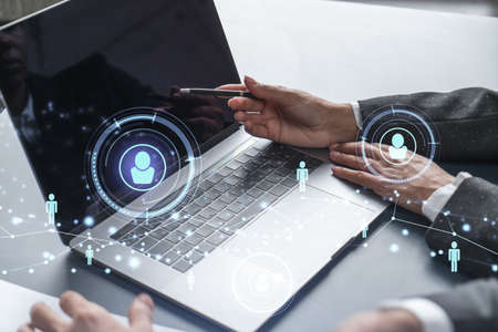 Two HR specialists analyzing the recruitment market using laptop to boost the intern program at...