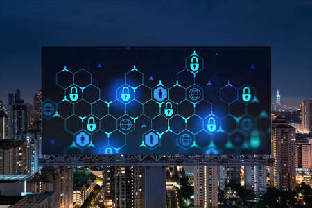 Padlock icon hologram on road billboard over panorama city view of Kuala Lumpur at night to protect...