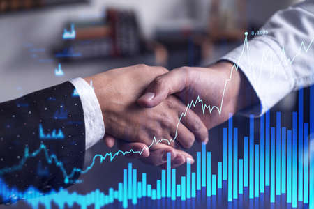 A handshake as a symbol of successful transaction on brokerage services at international investment...