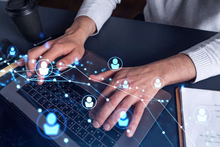 Hands of hr specialist is typing the keyboard in the internet to find the best candidates to create...