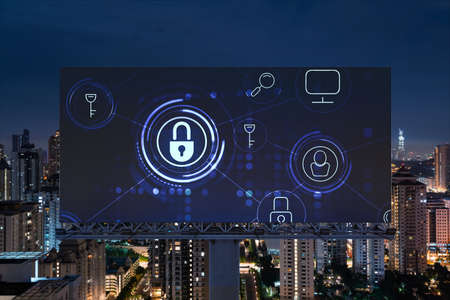Padlock icon hologram on road billboard over panorama city view of Kuala Lumpur at night to protect...